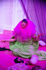 Caryl Loria Illana as a flower with pink tutu petals, a green tunic, and hands playing leaves