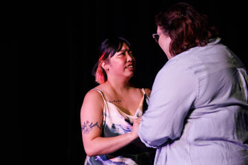Caryl Loria Illana as Harper in Solarise, distressed with her back to Harper's wife Caryl Loria Illana as Harper in Solarise, distressed with her back to Harper's wife