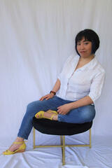 Caryl Loria Illana sitting on a stool Caryl Loria Illana sitting on a stool