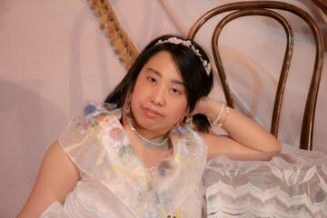 Caryl Loria Illana leaning on a chair Caryl Loria Illana leaning on a chair