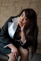 Caryl Loria Illana as Mia Fey, sitting like The Thinker statue, looking into camera Caryl Loria Illana as Mia Fey, sitting like The Thinker statue, looking into camera