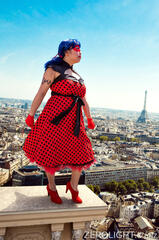 Caryl Loria Illana as Ladybug, power posing over a city