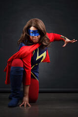 Caryl Loria Illana as Kamala Khan Ms. Marvel in a three point landing