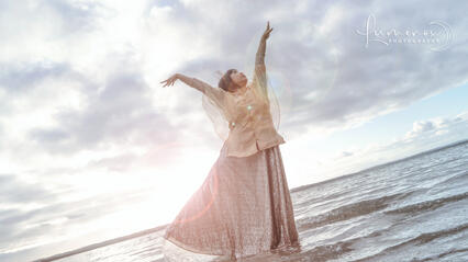 Caryl as the star goddess Tala, arms and one leg up